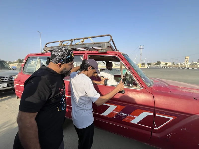 Preparing the red car for filming.